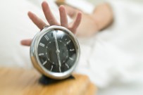 Woman turning off alarm clock