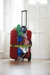 Overstuffed suitcase in hallway